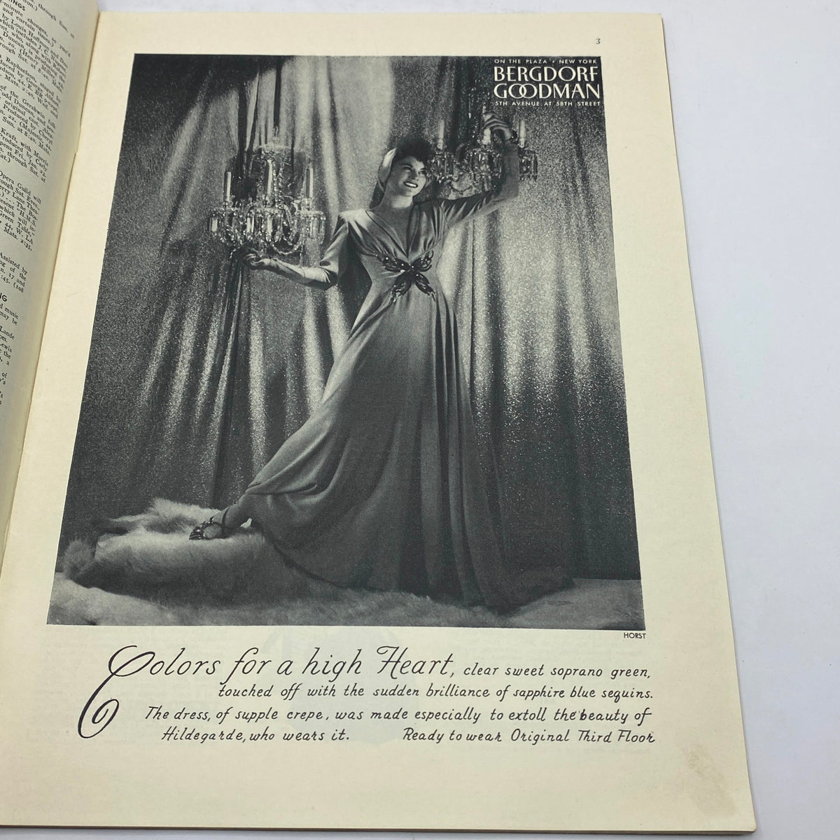 Vintage advertisement from The New Yorker magazine January 17, 1942 featuring a model showcasing a glamorous dress and chandelier, promoting Bergdorf Goodman.