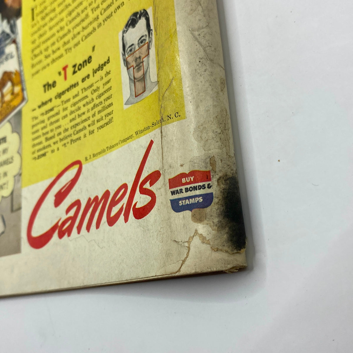 Close-up of the vintage advertisement from The New Yorker Complete Magazine June 5, 1943, showcasing the Camels cigarette branding and a section emphasizing the importance of war bonds.