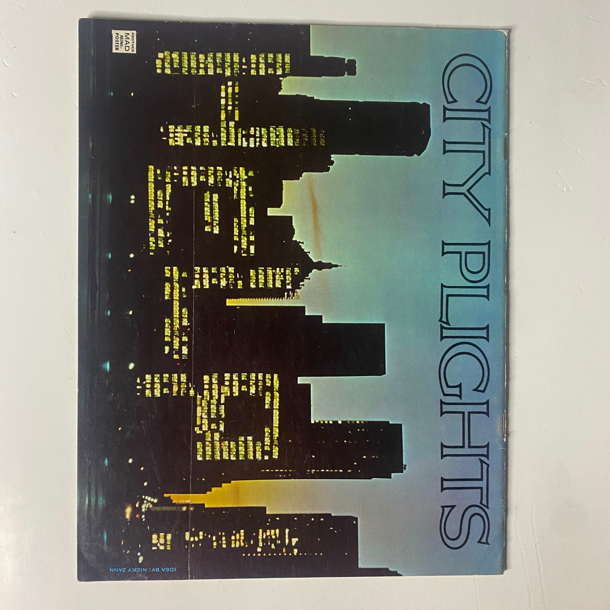 Back cover of Mad Magazine March 1976 No. 181, featuring a city skyline illuminated at night with the title 'City Plights', a classic touch reflecting the magazine's humor.