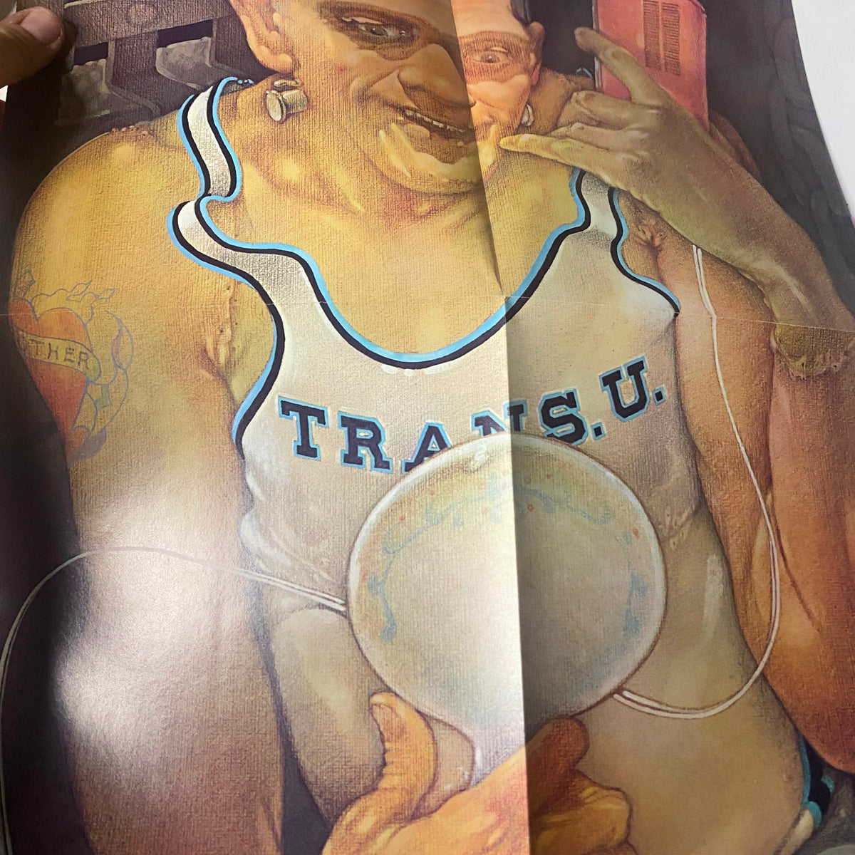 Fold-out poster from Bananas Magazine 1975 featuring a colorful and artistic illustration of a man in a swimsuit with the text 'TRANSU.' The vibrant design contributes to the magazine's quirky vintage aesthetic.