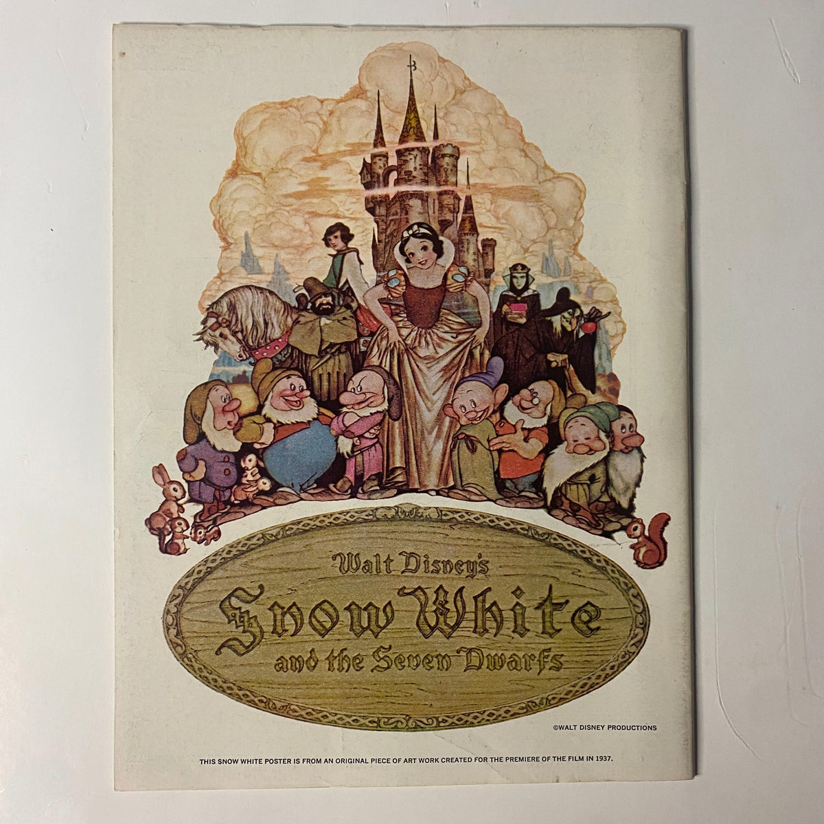 Back cover of Walt Disney's Snow White and the Seven Dwarfs promotional piece, featuring iconic characters from the film, highlighting its significance in Disney history.