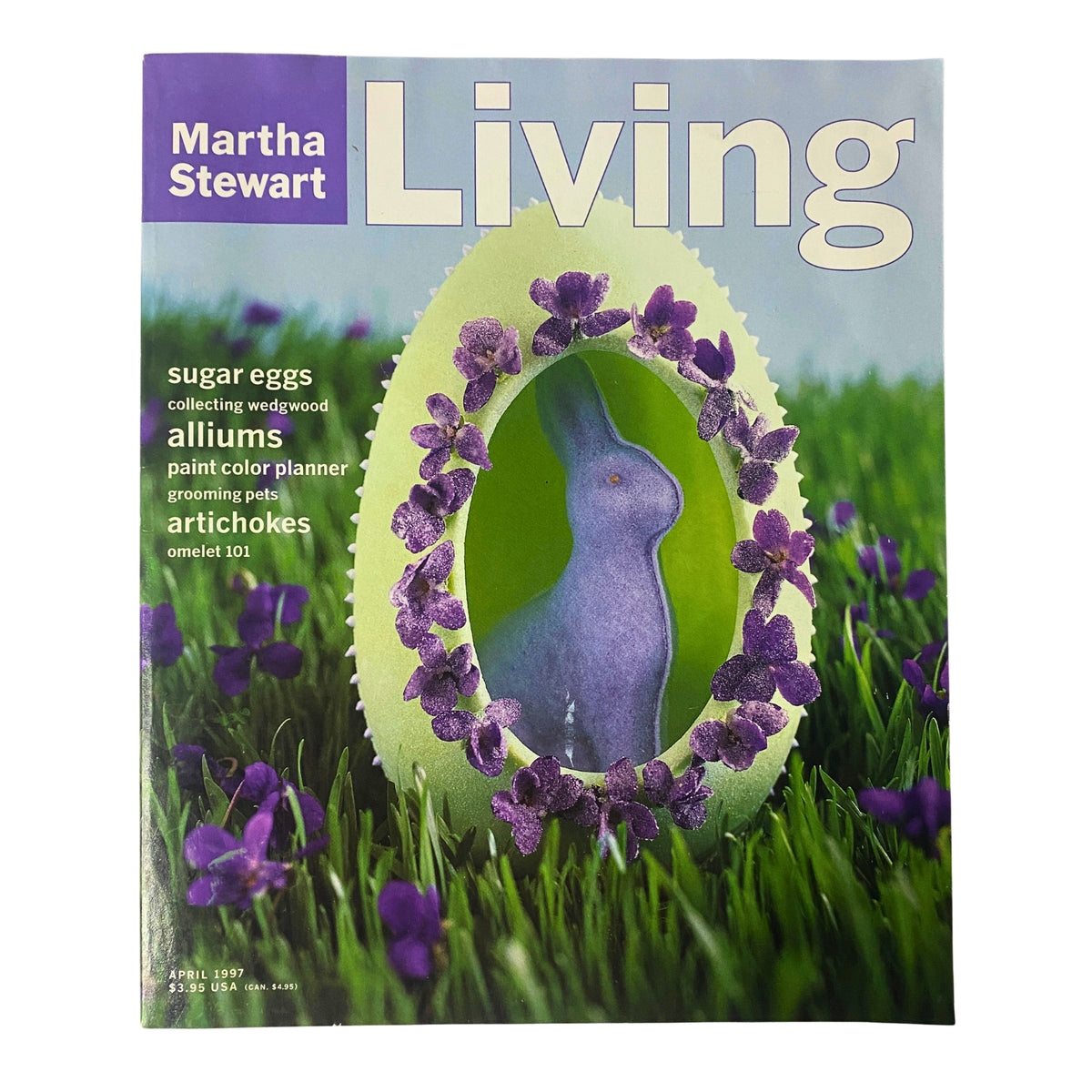 Cover of Martha Stewart Living Magazine April 1997 featuring a large-view sugar egg for Easter, vibrant purple flowers and a blue rabbit figurine as the focal point.