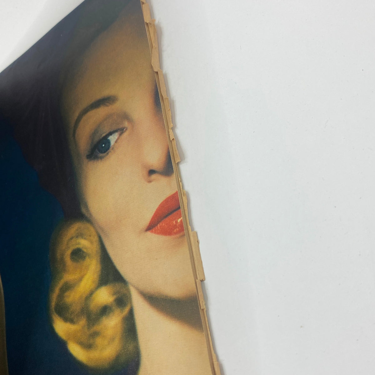 Close-up of a vintage full-color advertisement featuring a stylish woman, taken from The New Yorker magazine from October 4, 1947, showcasing 1940s fashion.