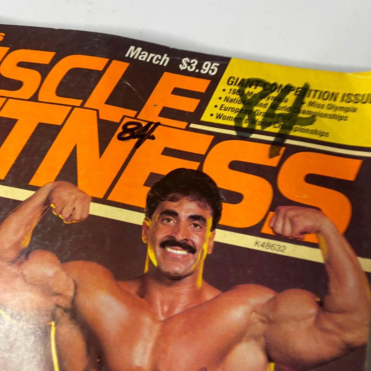 Close-up of the cover of Muscle & Fitness Magazine March 1984, showcasing Samir Bannout flexing, emphasizing his prominent role as a bodybuilding champion.