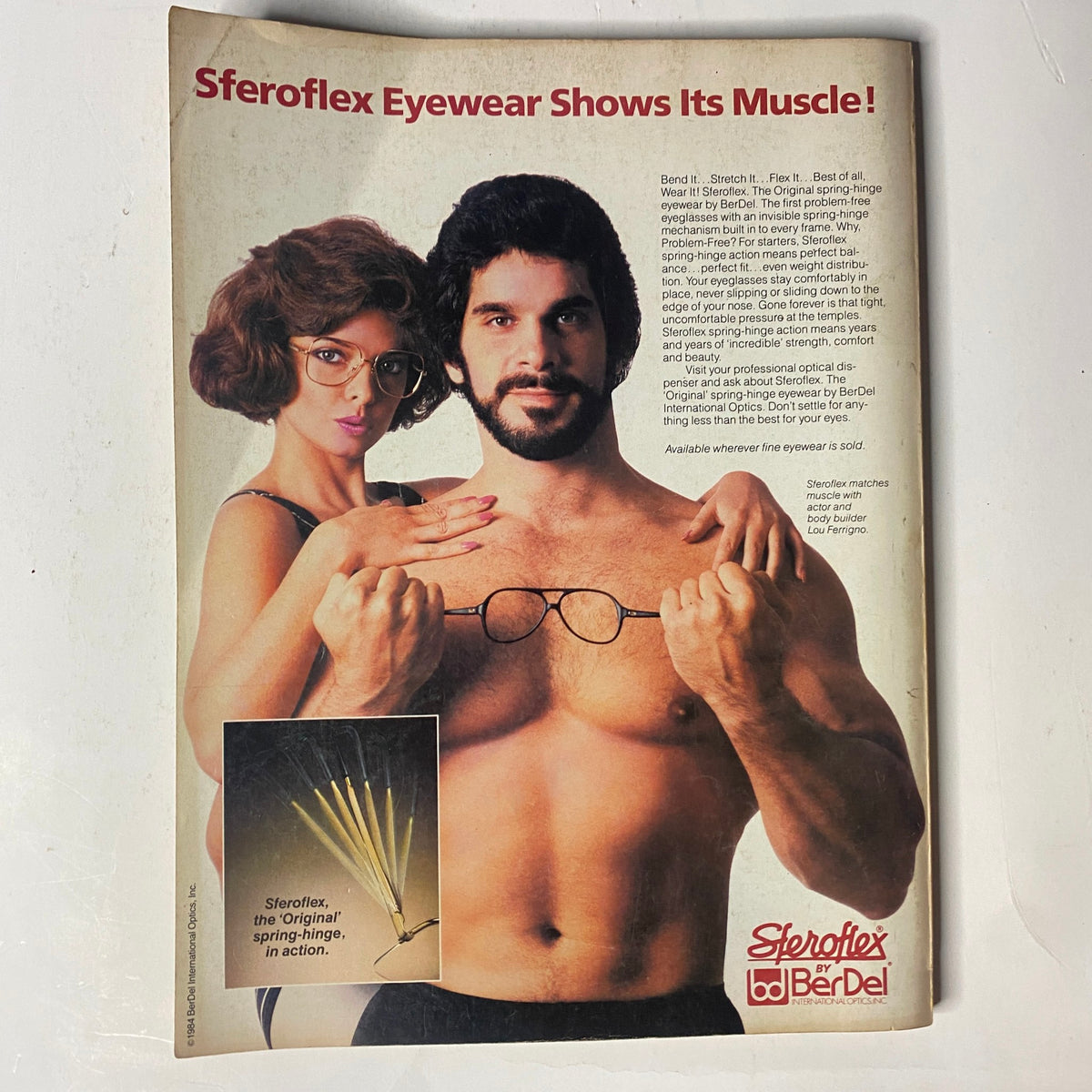 Sferoflex Eyewear advertisement from Muscle & Fitness Magazine September 1984, featuring a model and a man exhibiting muscles while showcasing eyewear products.