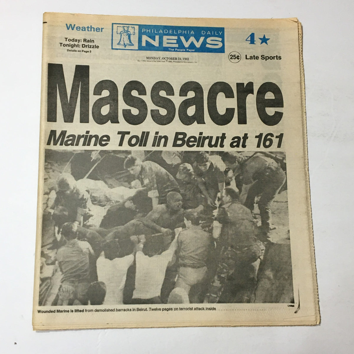 VTG Philadelphia Daily News October 24 1983 - Wounded Marine Toll in Beirut, featuring the headline 'Massacre Marine Toll in Beirut at 161' with an image of rescuers attending to a wounded Marine.