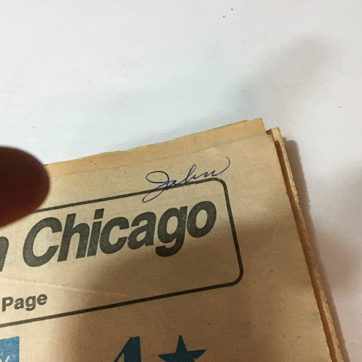 Close-up of the Philadelphia Daily News dated September 8, 1982, showing a handwritten signature above the headline regarding a Chicago sports update.