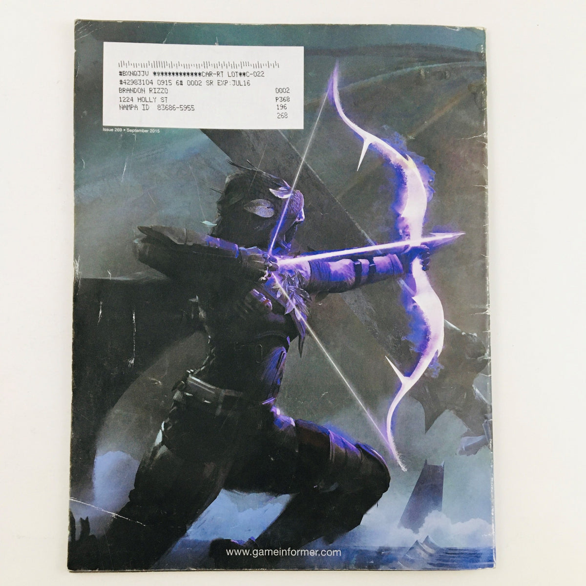 Back cover of Game Informer Magazine September 2015 Issue 269 showcasing artwork of a character with a bow and arrow, highlighting the magazine's artistic design.