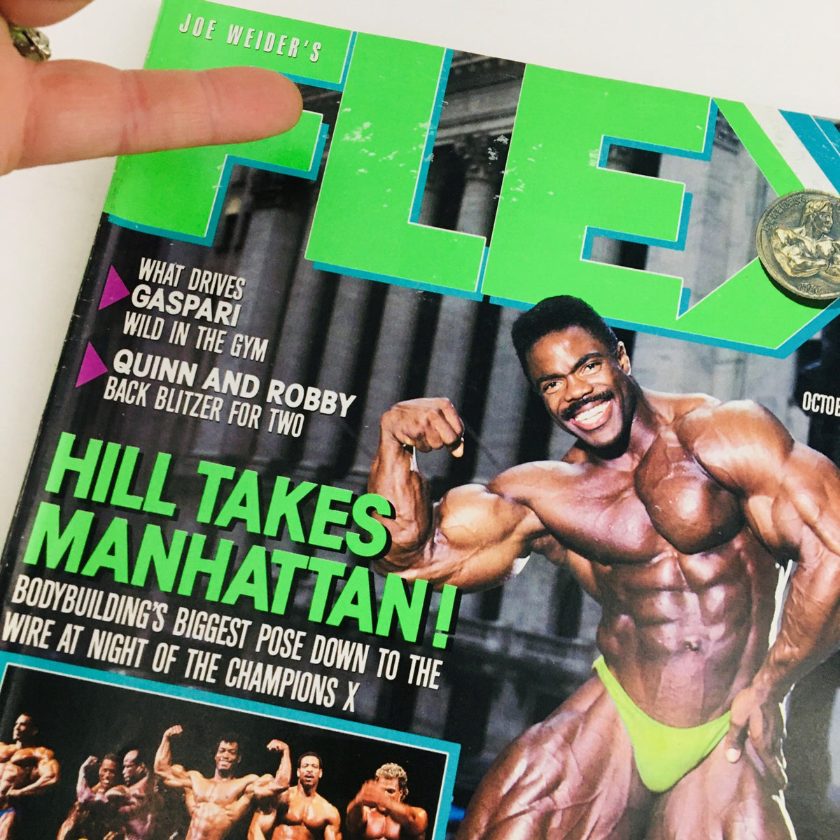 Close-up of the cover of Joe Weider's Flex Magazine, October 1988, with an emphasis on bodybuilder Phil Hill and the dynamic headline 'HILL TAKES MANHATTAN!'.