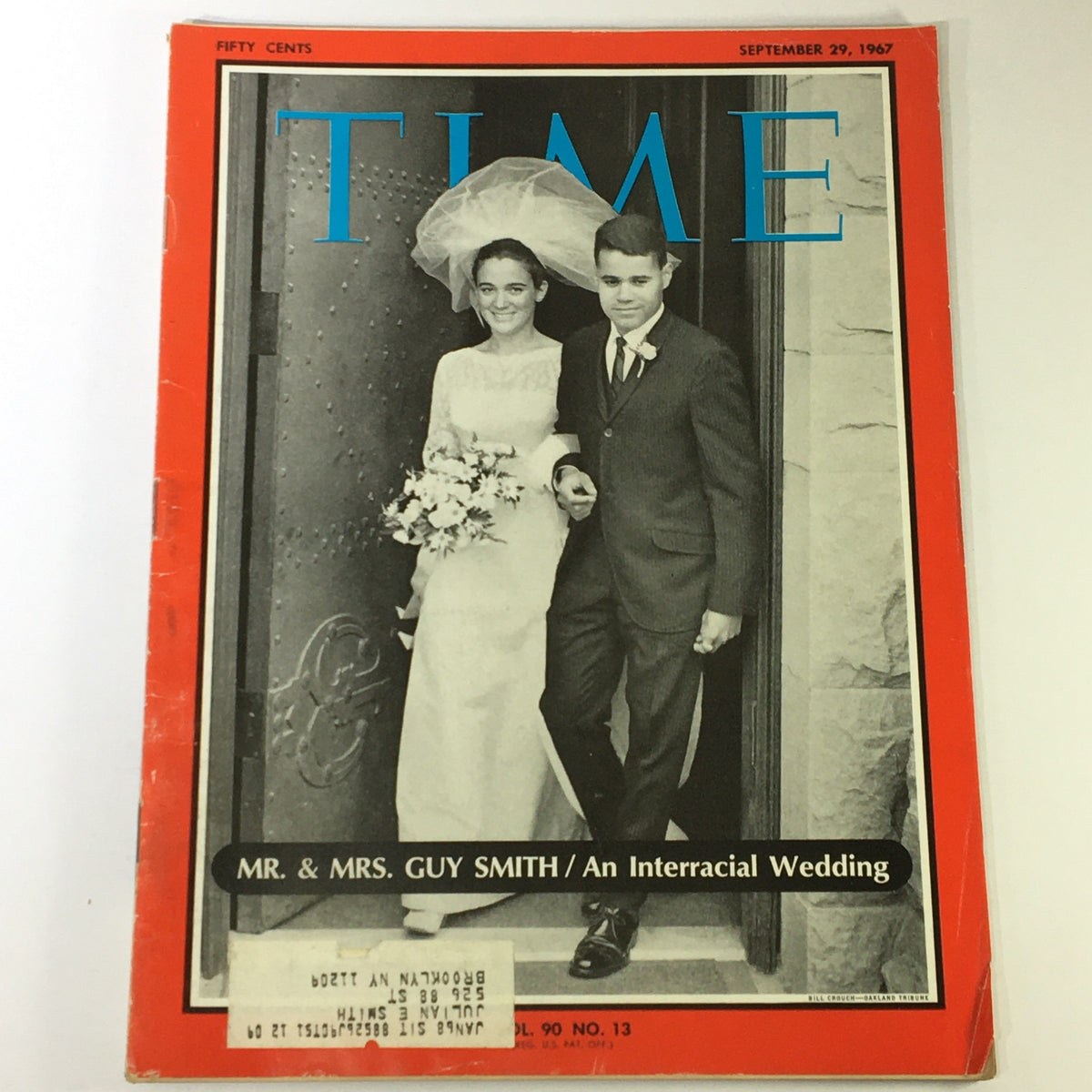 Cover image of VTG Time Magazine from September 29, 1967, featuring the title 'Mr. & Mrs. Guy Smith / An Interracial Wedding'. The photograph depicts a couple standing at the entrance of a building, showcasing their wedding attire and a bouquet of flowers, highlighting the significance of their interracial wedding.