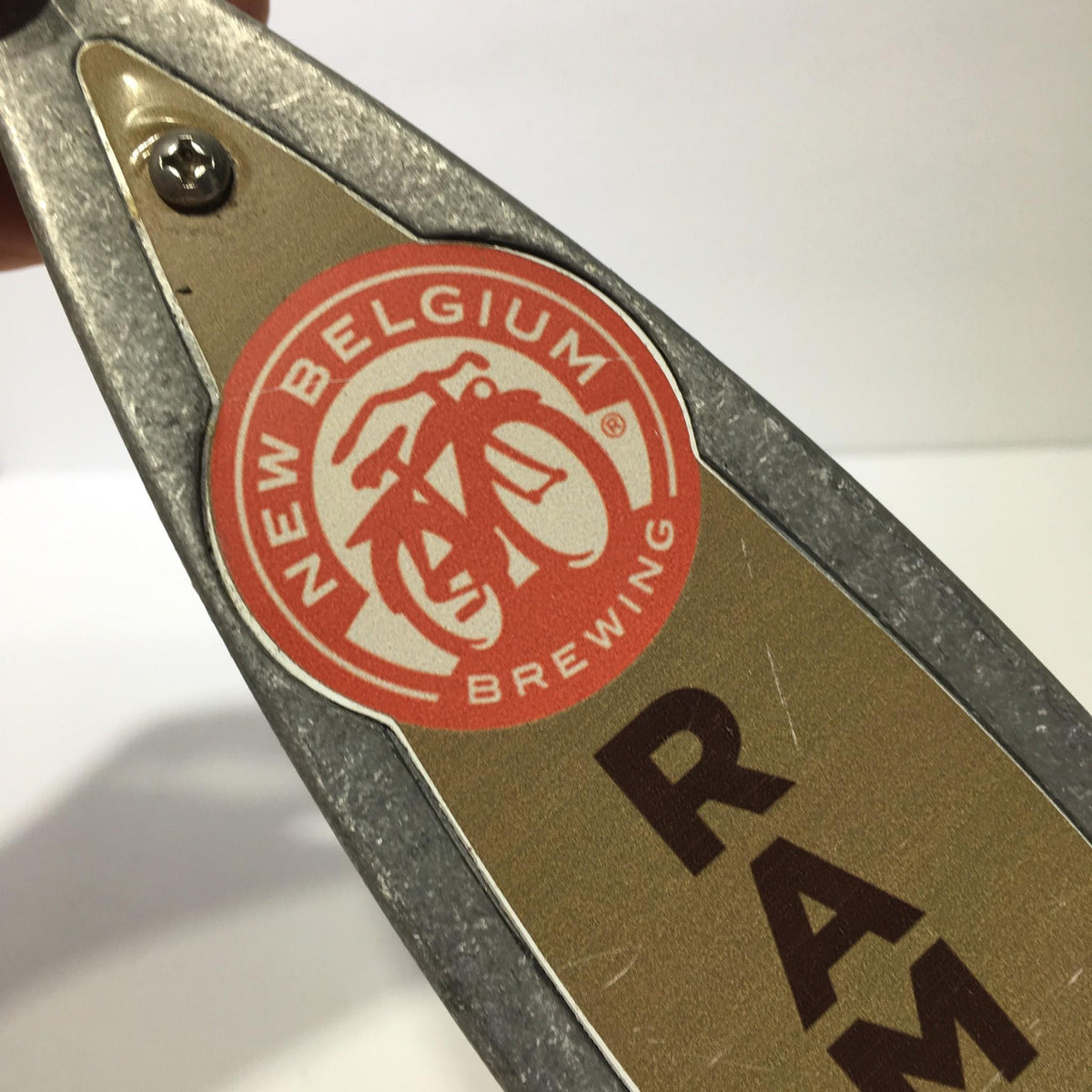 Highlighted logo on the Vintage New Belgium Brewing Rampant Imperial IPA 11" Beer Tap Handle featuring New Belgium Brewing's iconic bicycle design.