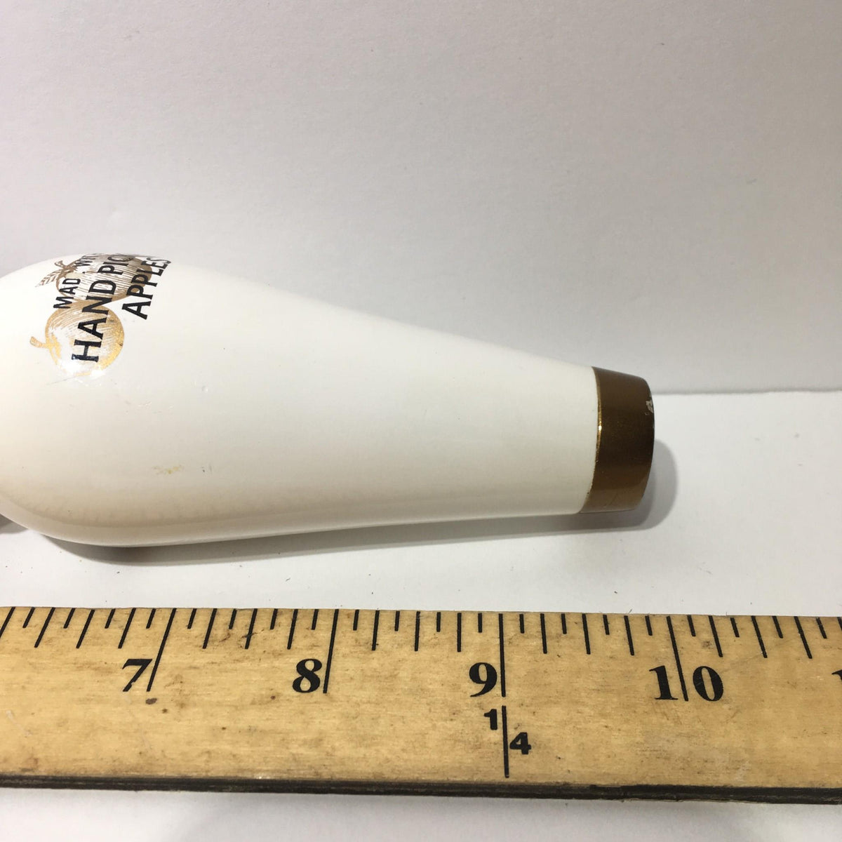 Side view of a Vintage Stella Artois Cidre 10" Beer Tap Handle with a ruler measuring its length.