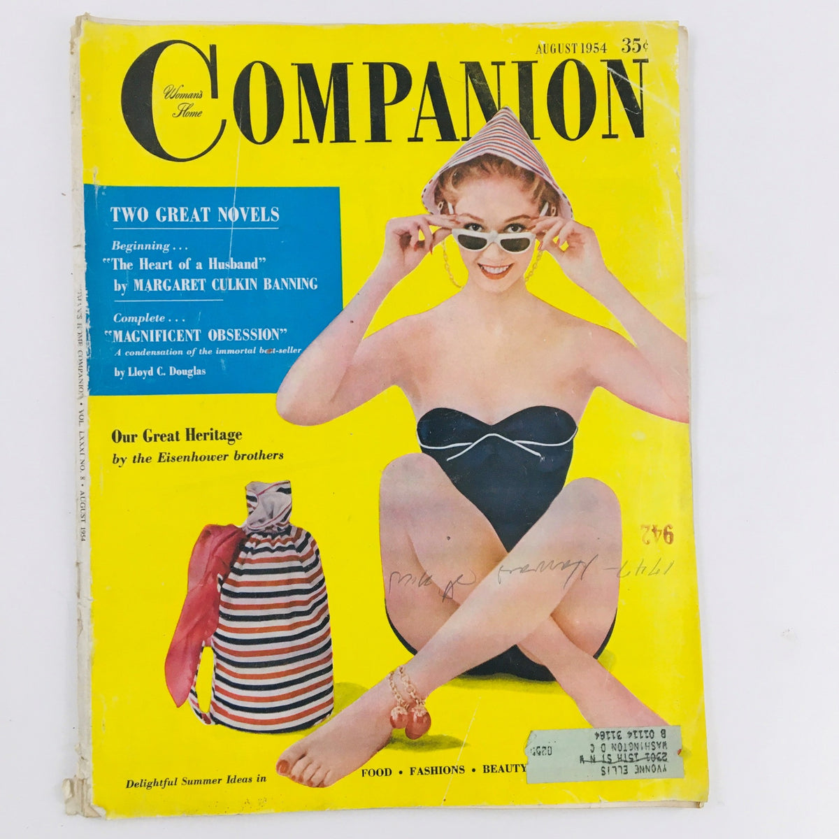 Cover of Woman's Home Companion, August 1954 featuring a young woman in a black swimsuit, stylish sunglasses, and a striped beach bag, reflecting mid-century fashion trends.
