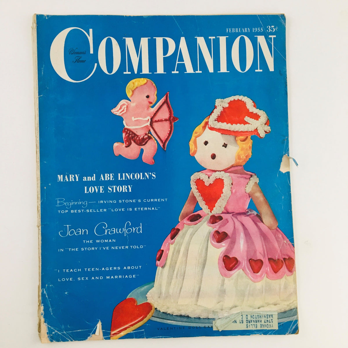 Cover of Woman's Home Companion February 1955 issue featuring the love story of Mary and Abe Lincoln with a colorful illustration of a doll and cherub.