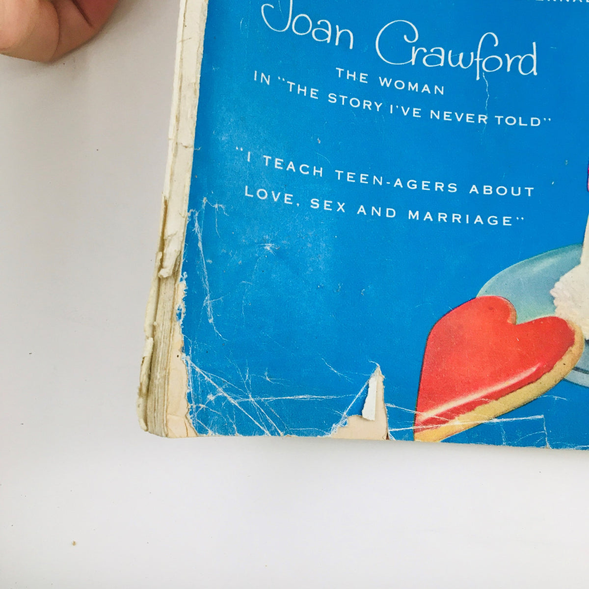 Detail from the cover of Woman's Home Companion February 1955 showcasing text about Joan Crawford, the woman in the story never told, alongside heart-shaped graphics.