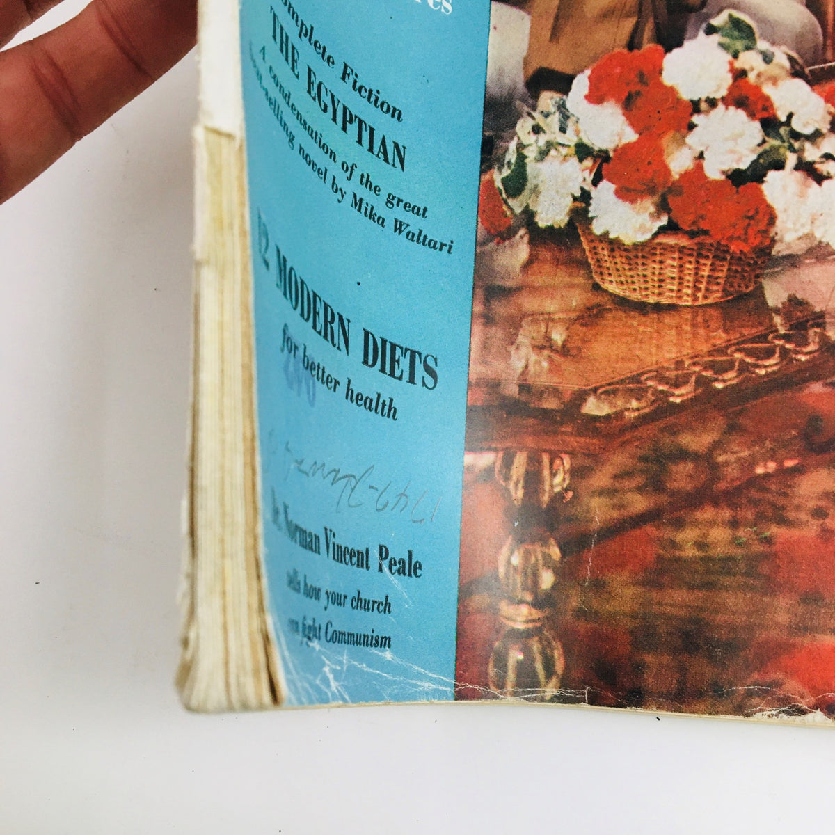 Side view of Woman's Home Companion October 1954, showing the condition of the spine and a glimpse of the contents,