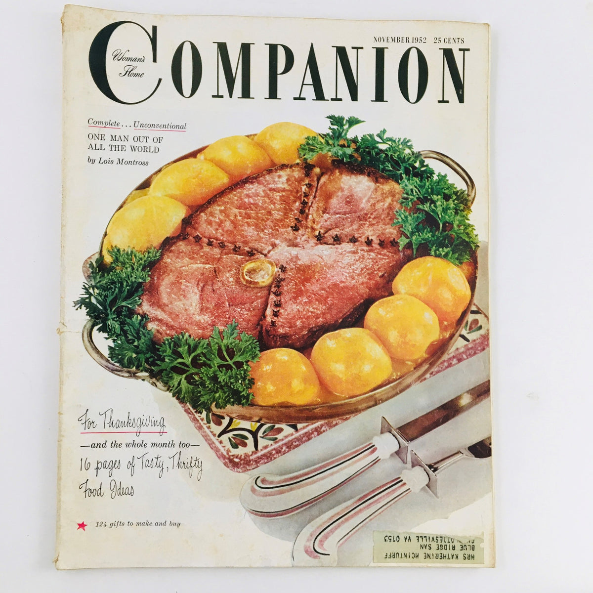 Cover of Woman's Home Companion November 1952 featuring the title 'One Man Out Of All The World' by Lois Montross, showcasing a delicious meat dish surrounded by yellow oranges, emphasizing mid-20th century Americana aesthetics.