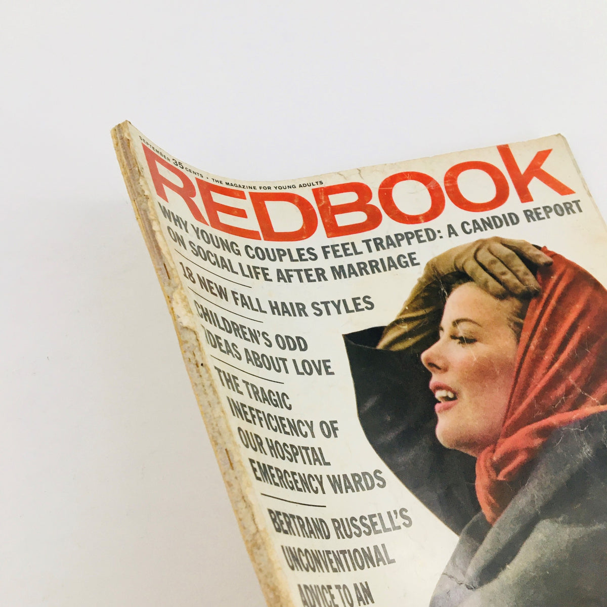 Side view of Redbook Magazine September 1964, showcasing the prominent title and features on the cover related to marriage and Bertrand Russell's advice.