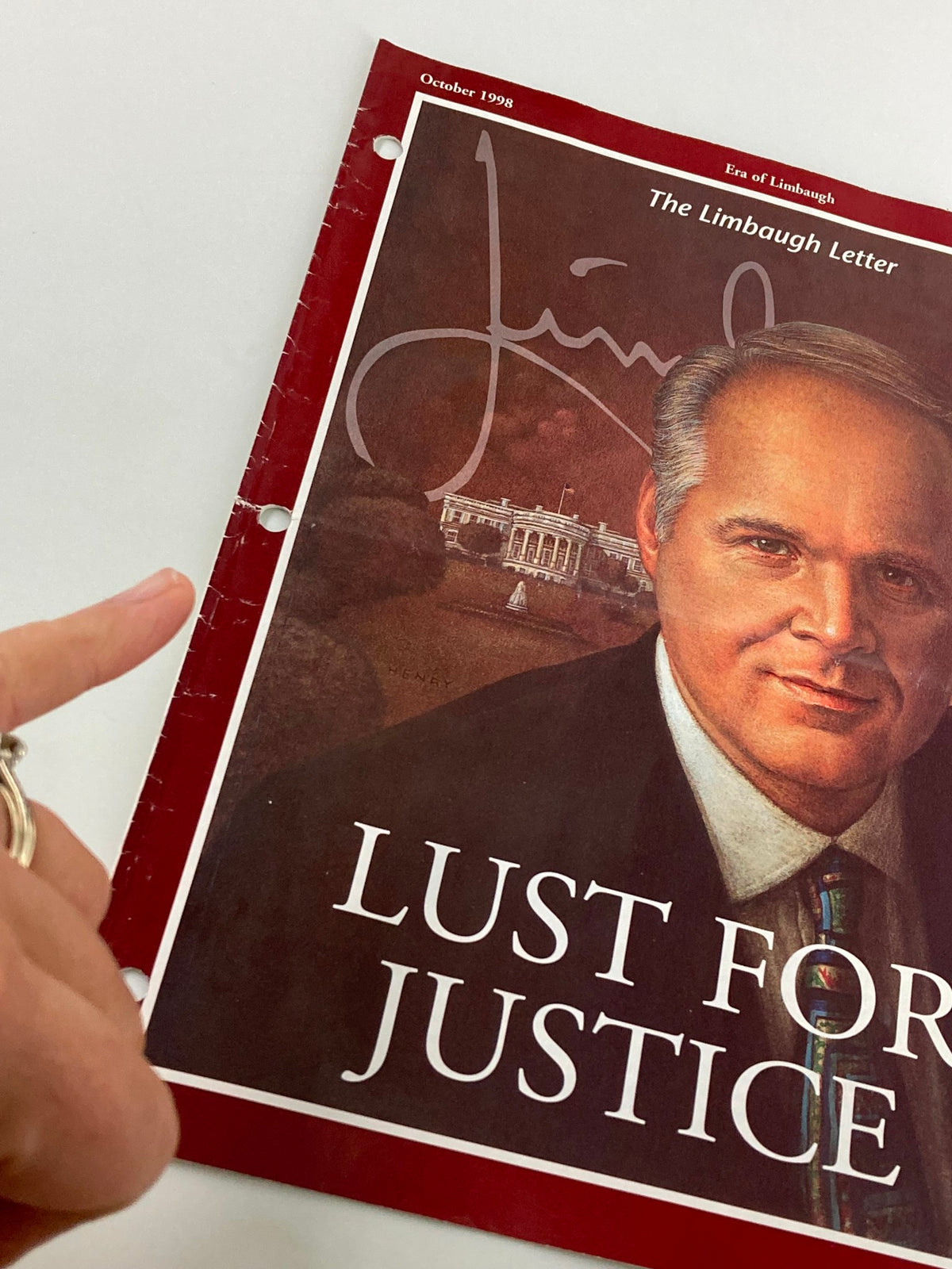 Close-up of the Rush Limbaugh Letter Newsletter Magazine cover from October 1998, 'Lust for Justice,' showing details such as the publication's title and Limbaugh's signature, along with a finger pointing at the cover.