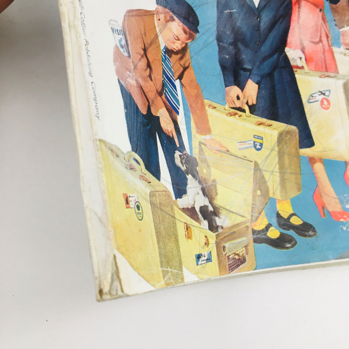 Detailed view of the cover of The American Magazine, June 1952, highlighting the character with a suitcase and a dog, part of the article 'How To Get Along In The Army' by Curt Simmons.