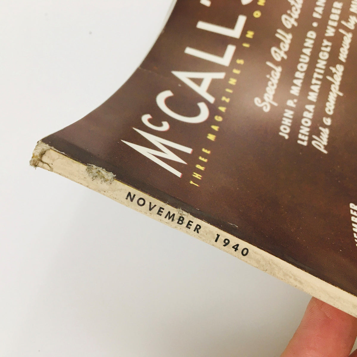 Spine detail of the vintage McCall's Magazine from November 1940, highlighting the edition date and authentic wear, adding character to this collectible.