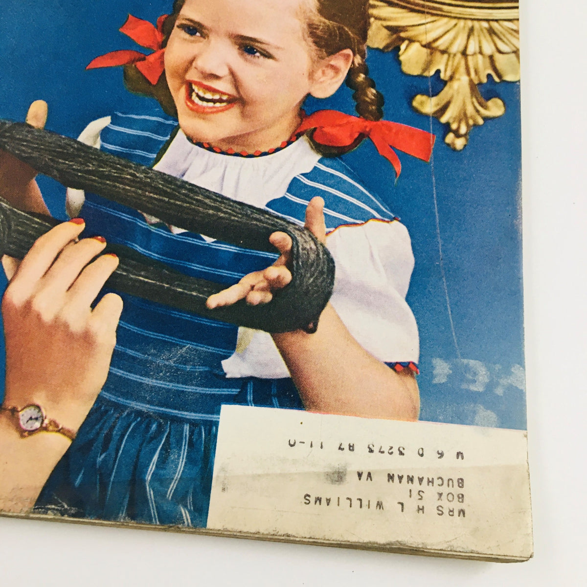 Close-up of a page from VTG McCall's Magazine October 1940, highlighting a joyful child holding yarn, associated with the article 'Husbands are Perishables' by Faith Baldwin.