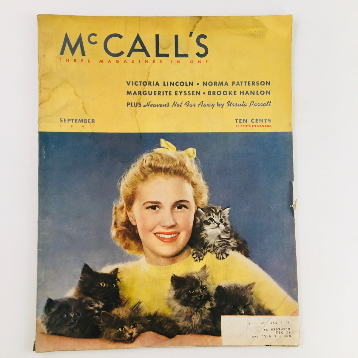Cover of the September 1941 issue of McCall's Magazine featuring the title 'Heaven's Not Far Away' by Ursula Parrott, showcasing a smiling young woman with blonde hair, surrounded by fluffy kittens, reflecting vintage aesthetics.