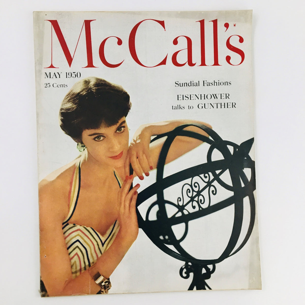 Cover of VTG McCall's Magazine May 1950 featuring a young woman in a striped swimsuit, showcasing the magazine's retro design and the title prominently displayed.