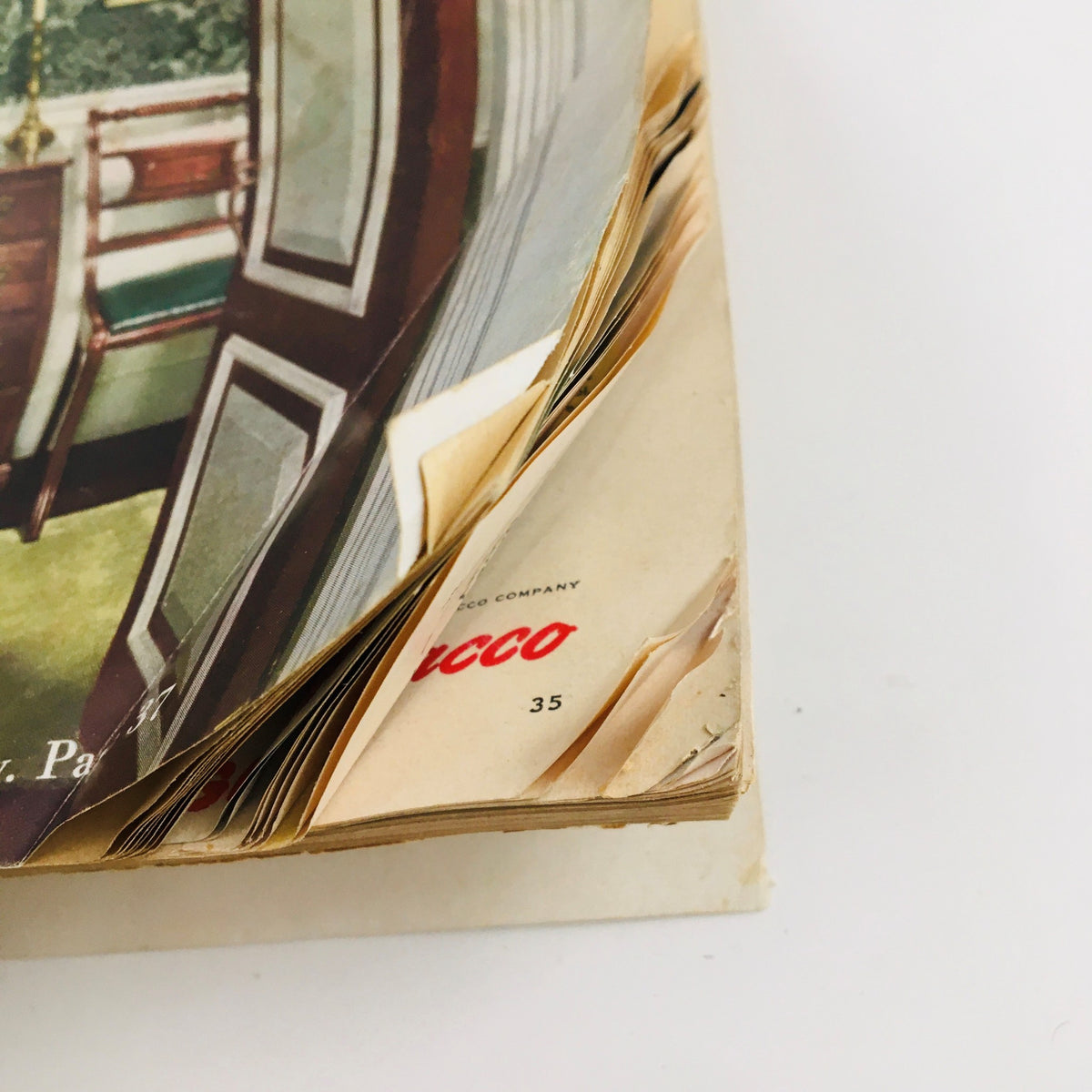 Close-up view of the spine and pages of Better Homes & Gardens Magazine March 1949, highlighting the magazine's aged condition with curled pages and a vintage publication label.