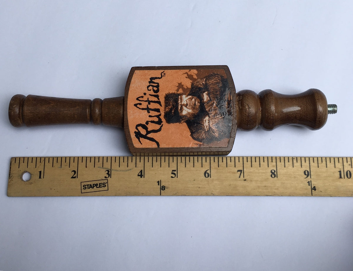 Side view of the Vintage Ruffian Porter Wooden 10" Beer Tap Handle showing the dimensions next to a ruler, emphasizing its collectible size and unique design.