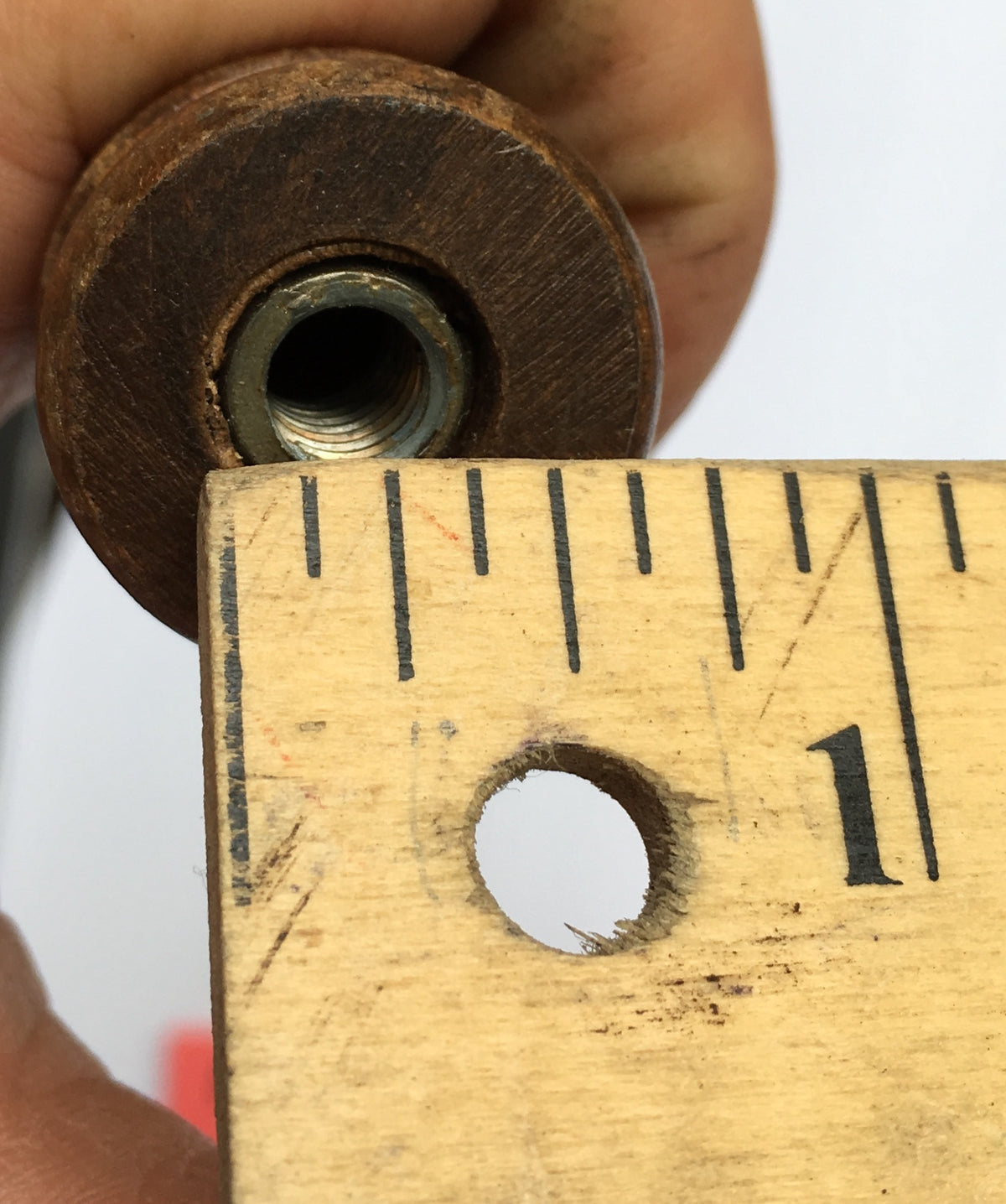 Close-up of Vintage Ruffian Porter Wooden 10" Beer Tap Handle showcasing its threaded base against a wooden ruler for size reference.