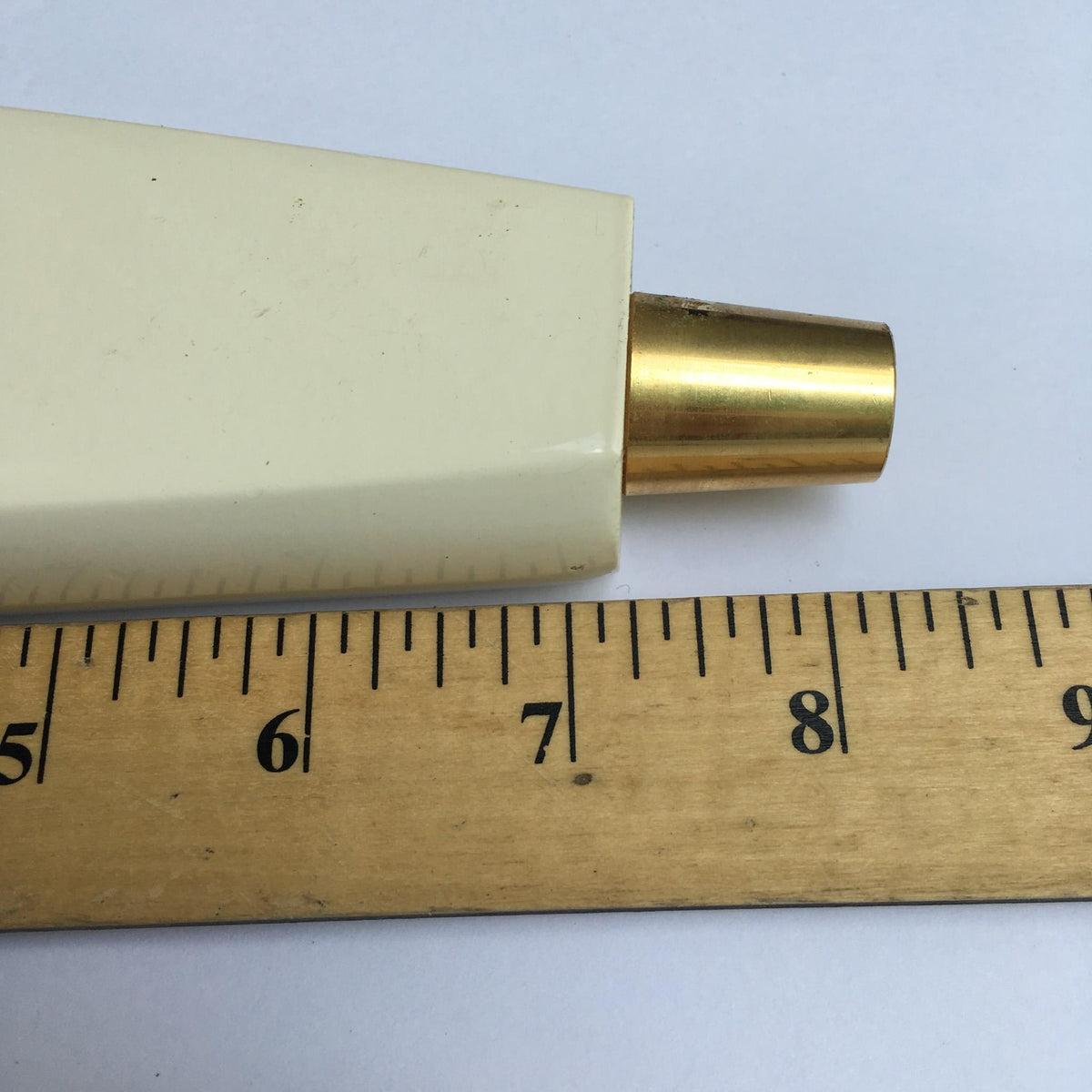 Close-up showing the end of Vintage Harpoon IPA Indian Pale Ale 8½" Beer Tap Handle next to a ruler for measurement.