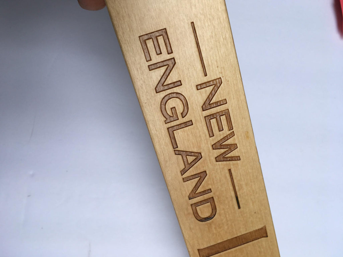 Detailed image of the Vintage Samuel Adams New England IPA 13" Beer Tap Handle showcasing the engraved text 'NEW ENGLAND'.