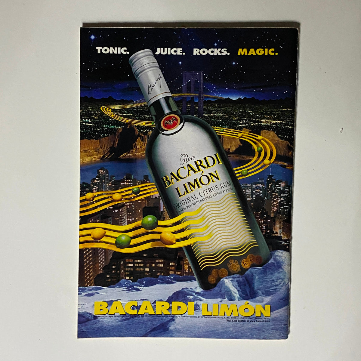 Advertisement for Bacardi Limón featured in Jet Magazine July 28, 1997, with a creative illustration of the rum bottle against a nighttime city backdrop.