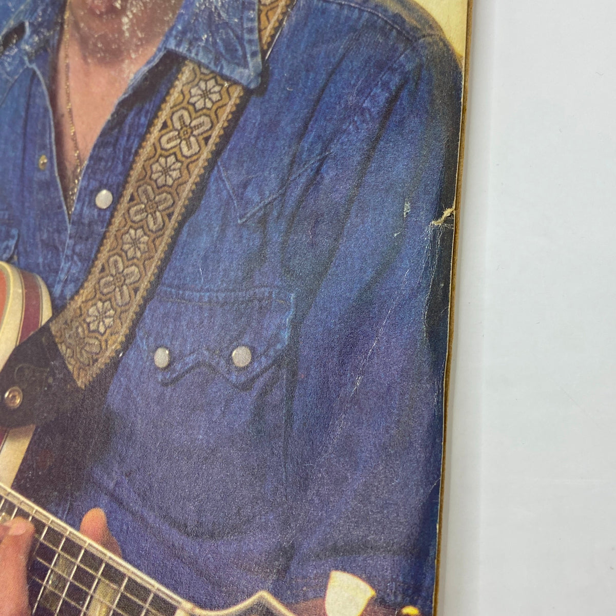 Close-up of Pat Martino on the cover of Guitar Player Magazine June 1977, highlighting his denim shirt and guitar, illustrating the vintage aesthetic of the era.
