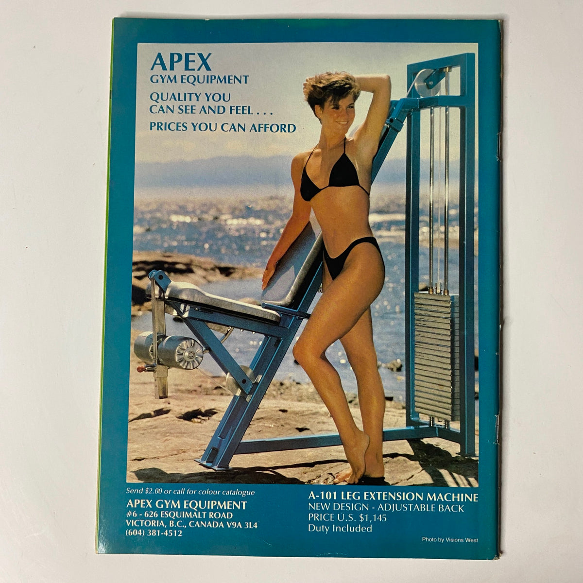 Advertisement for Apex Gym Equipment from the back cover of MuscleMag International Magazine May 1987 No. 65, showcasing fitness equipment for affordable prices with a model in a bikini.