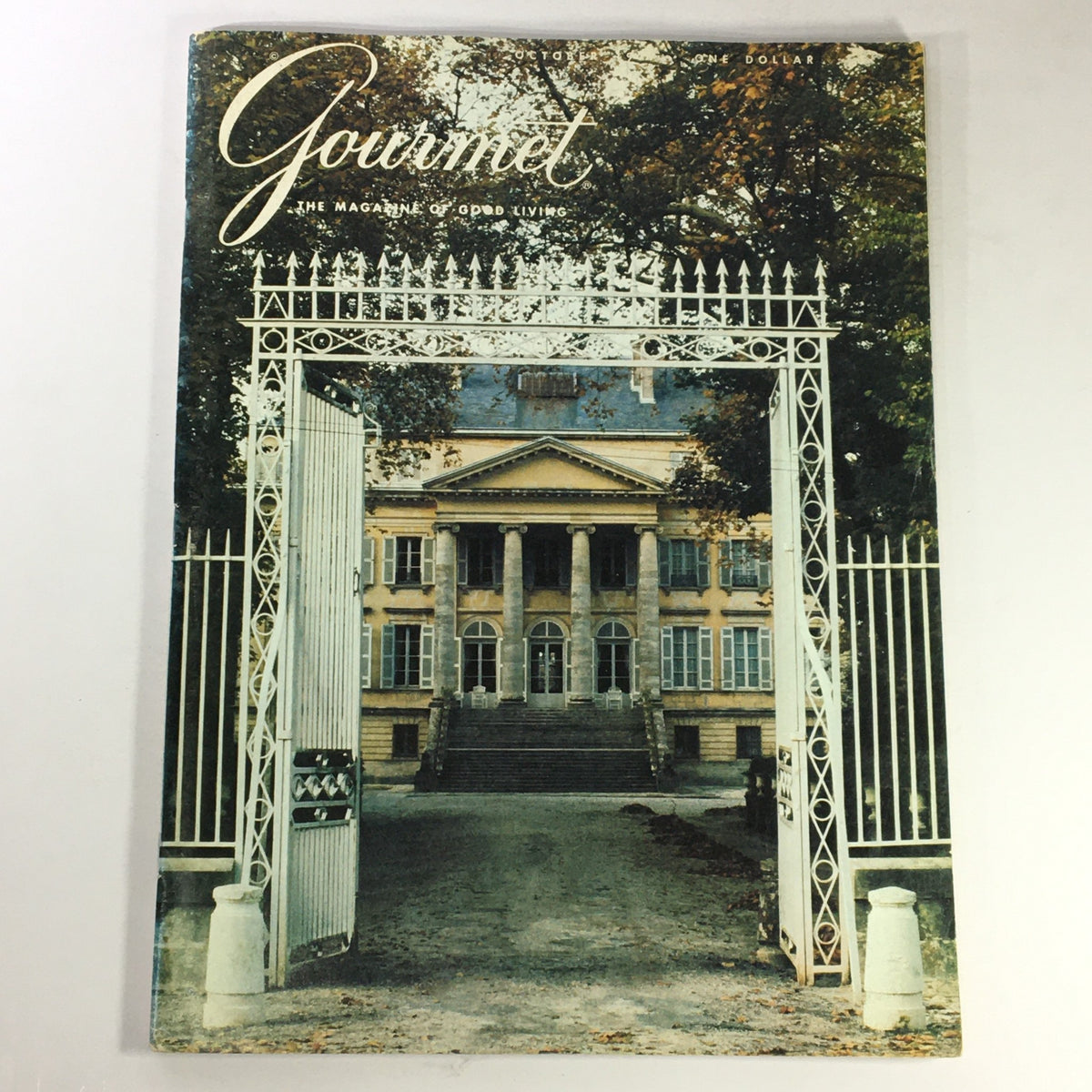 Cover of VTG Gourmet: The Magazine of Good Living, October 1977 edition, showcasing an elegant mansion entrance with white gates and a grand building in the background, reflecting the charm of Trinidad and Tobago's culinary culture.