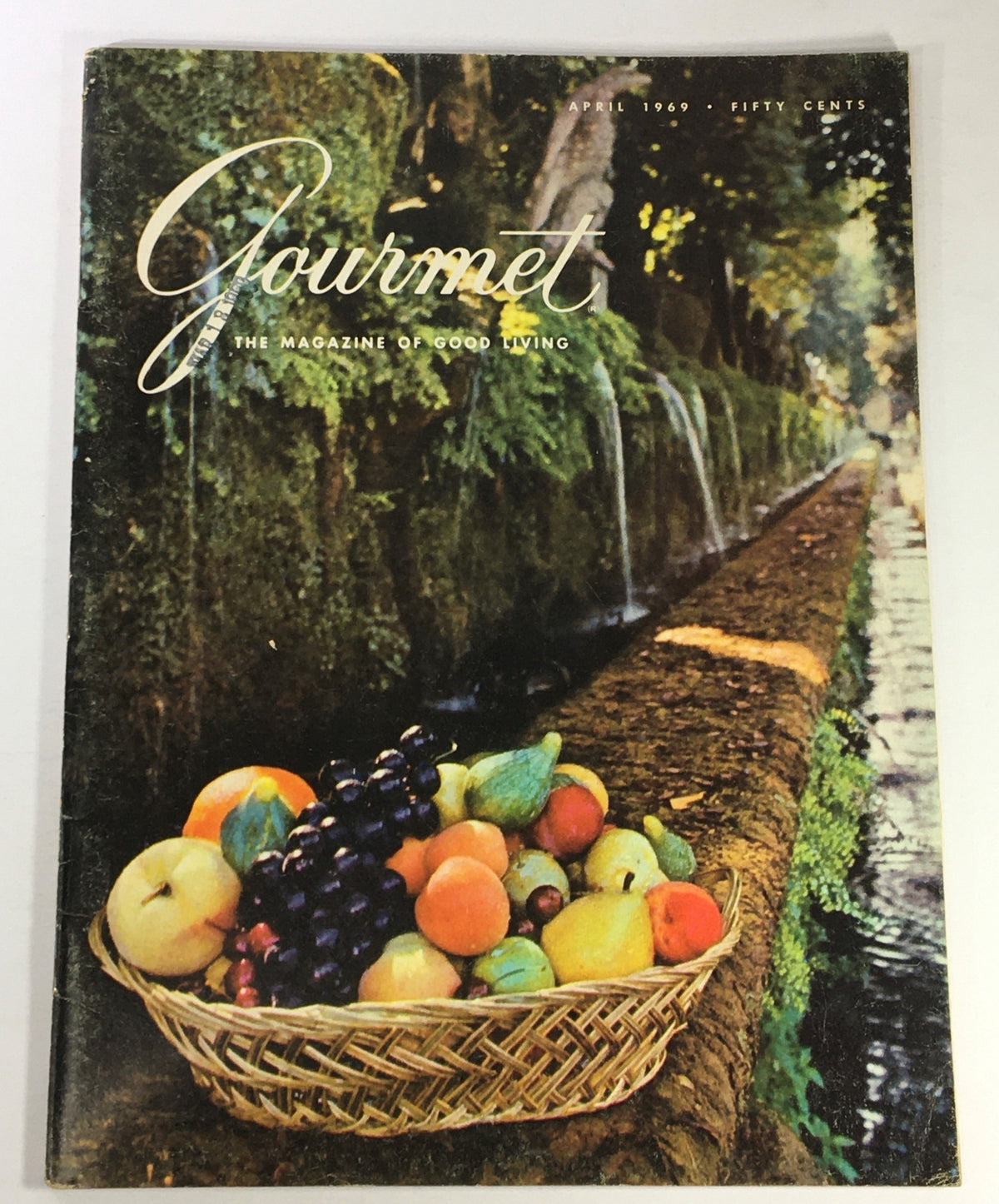 VTG Gourmet The Magazine of Good Living April 1969 cover featuring a vibrant fruit basket with apples, grapes, and other colorful fruits, set against a lush, green background.