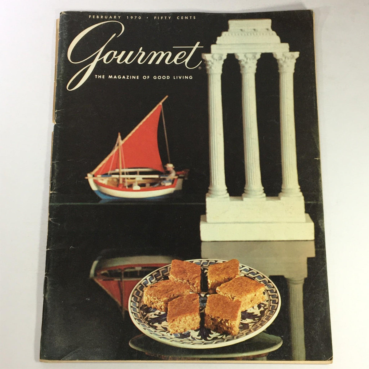Cover of VTG Gourmet The Magazine of Good Living February 1970 featuring a decorative plate with dessert, a model sailboat, and classical columns, illustrating the theme 'London at Table'.