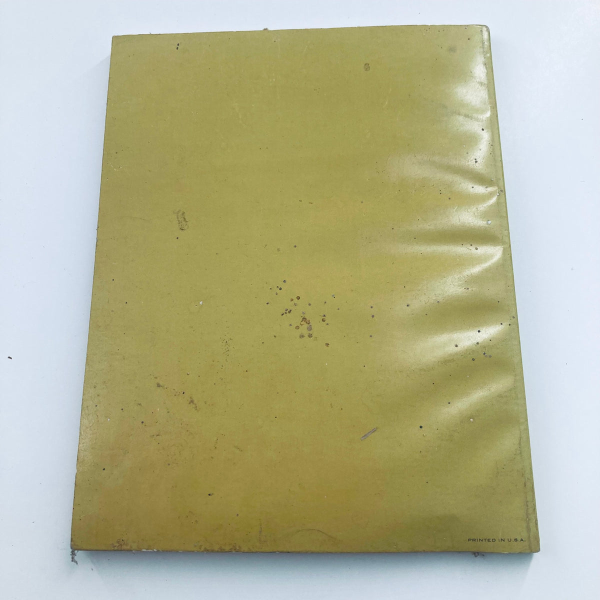Back cover of '1964 The Shining Moments: The Words and Moods of John F. Kennedy' showcasing a simple yellow design with minor imperfections typical of used books.