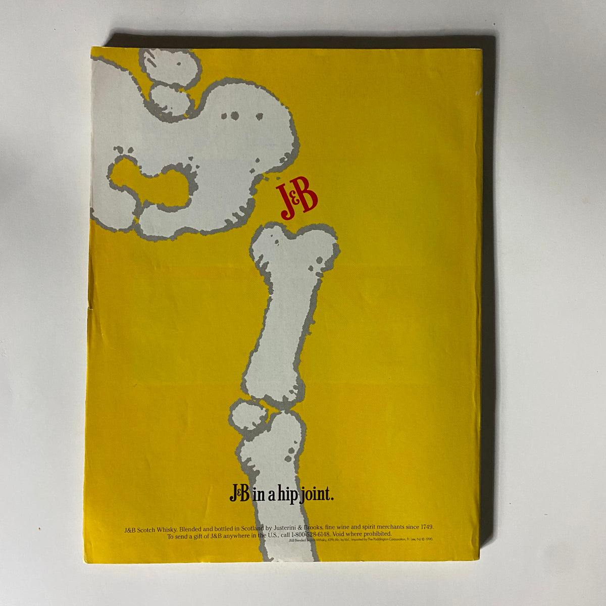 Back cover of Street & Smith's Pro Basketball 1990-1991 magazine showcasing a colorful advertisement for J&B Scotch whisky with a humorous bone illustration.