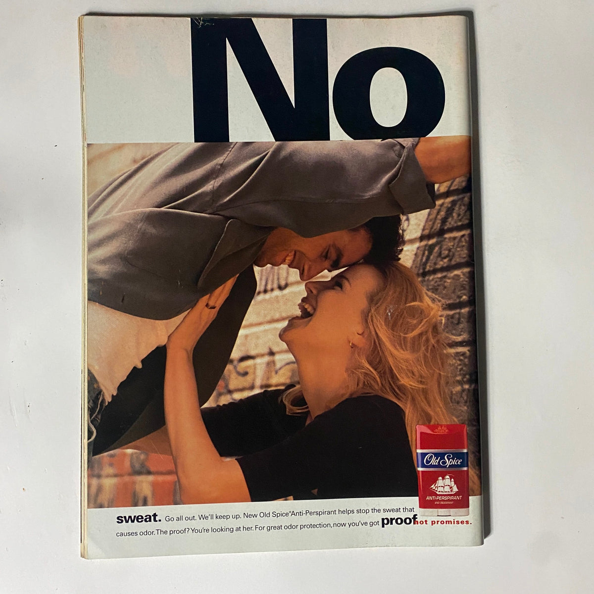 Vintage Old Spice advertisement depicting a couple in a playful embrace, emphasizing the brand's anti-perspirant benefits.