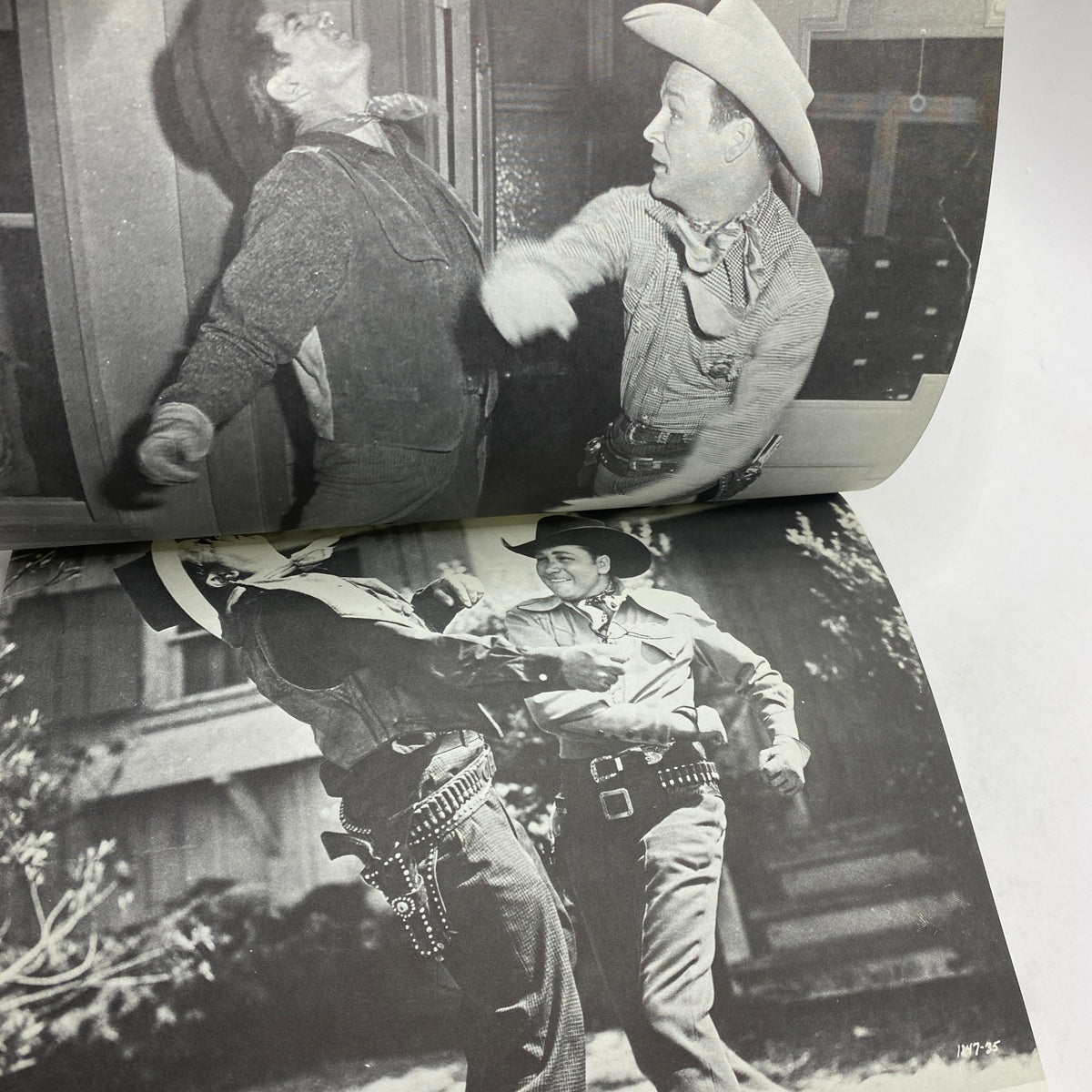 Action scene from a classic Western movie depicted in a vintage magazine, highlighting dynamic fight choreography, from the VTG Rex Allen Cover History of The B Western by Alan G. Barbour.