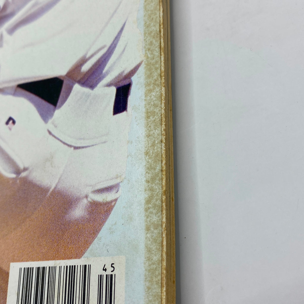 Close-up of the side of Street & Smith's Baseball Magazine 1994 featuring Aaron Sele with visible wear along the spine, showcasing vintage magazine characteristics.