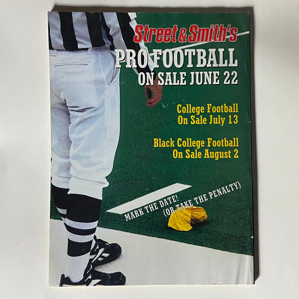 Back cover of Street & Smith's Pro Football magazine featuring a football referee with a yellow penalty flag, indicating upcoming issues for college and black college football.