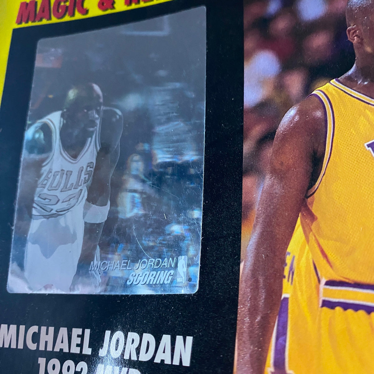 Close-up of the Sport Magazine Basketball 1992-1993 Pro Review showcasing Michael Jordan's scoring action and details of his 1992 MVP award next to Shaquille O'Neal, emphasizing significant moments in basketball history.