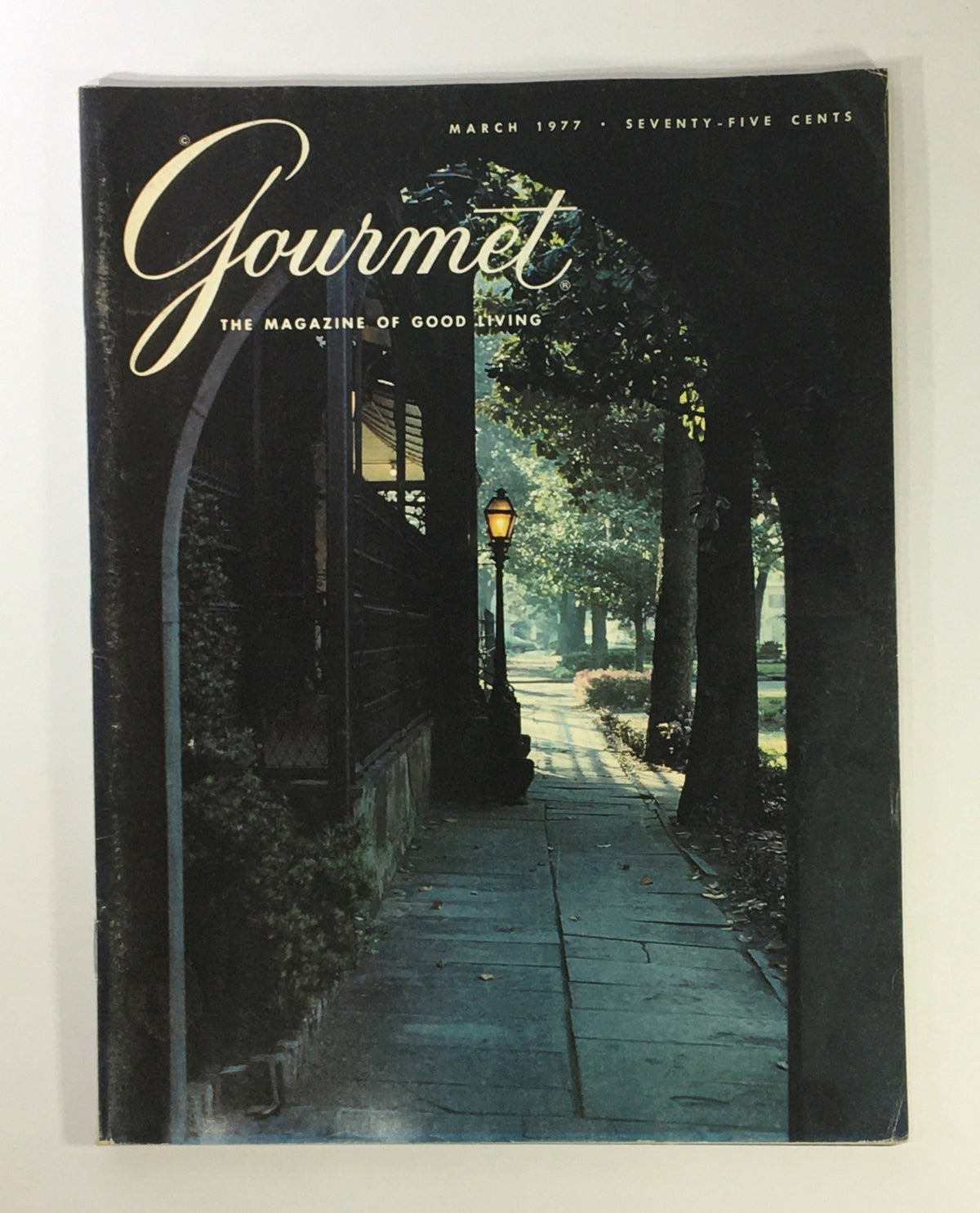 Cover of Gourmet Magazine, March 1977 edition featuring a serene pathway and lamppost, highlighting shopping in Dublin, Ireland.