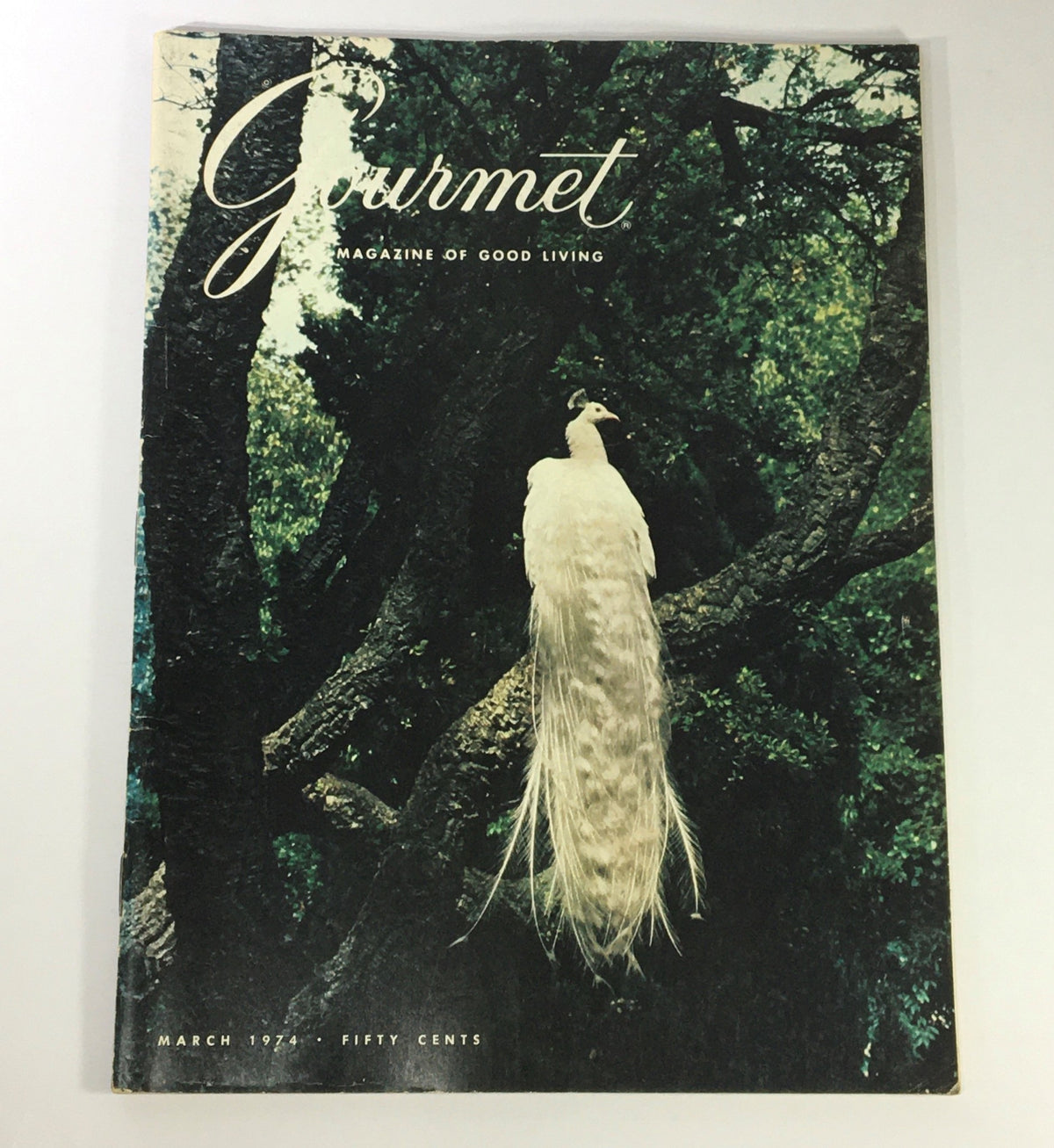 Cover of VTG Gourmet: The Magazine of Good Living, March 1974, featuring a white peacock perched on a tree in a lush setting.