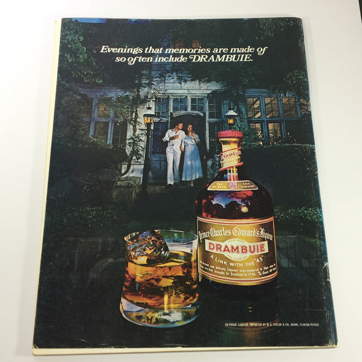 Back cover of VTG Gourmet The Magazine of Good Living May 1977, showcasing a DRAMBUIE advertisement with a bottle and glass, set against a romantic outdoor scene.