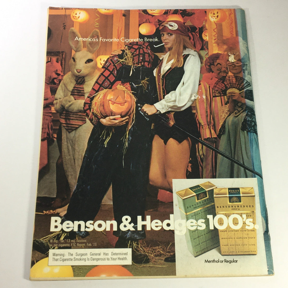 Back cover advertisement for Benson & Hedges 100's cigarettes in a festive Halloween setting, showcasing characters in costumes and celebrating the magazine's vintage style.